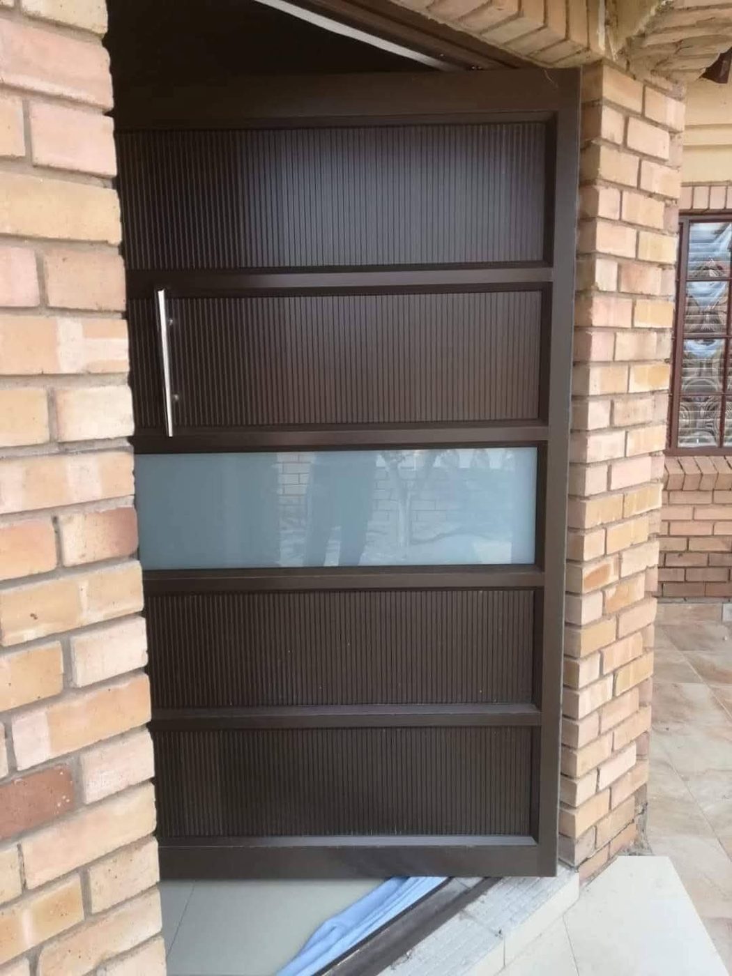 Textured aluminium door with frosted glass strip